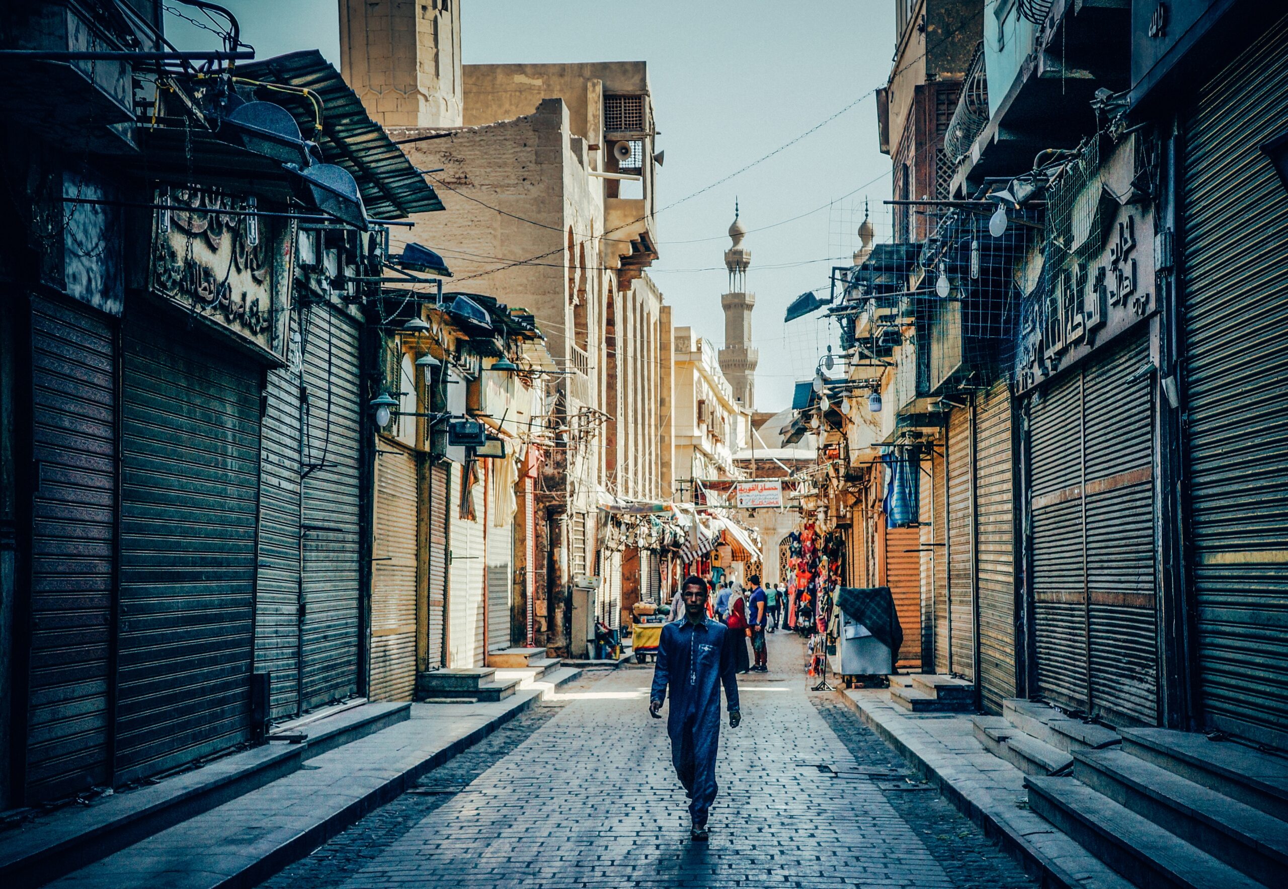 A guy walking the streets of Islamic Cairo by Alejandro Garcia via Unsplash