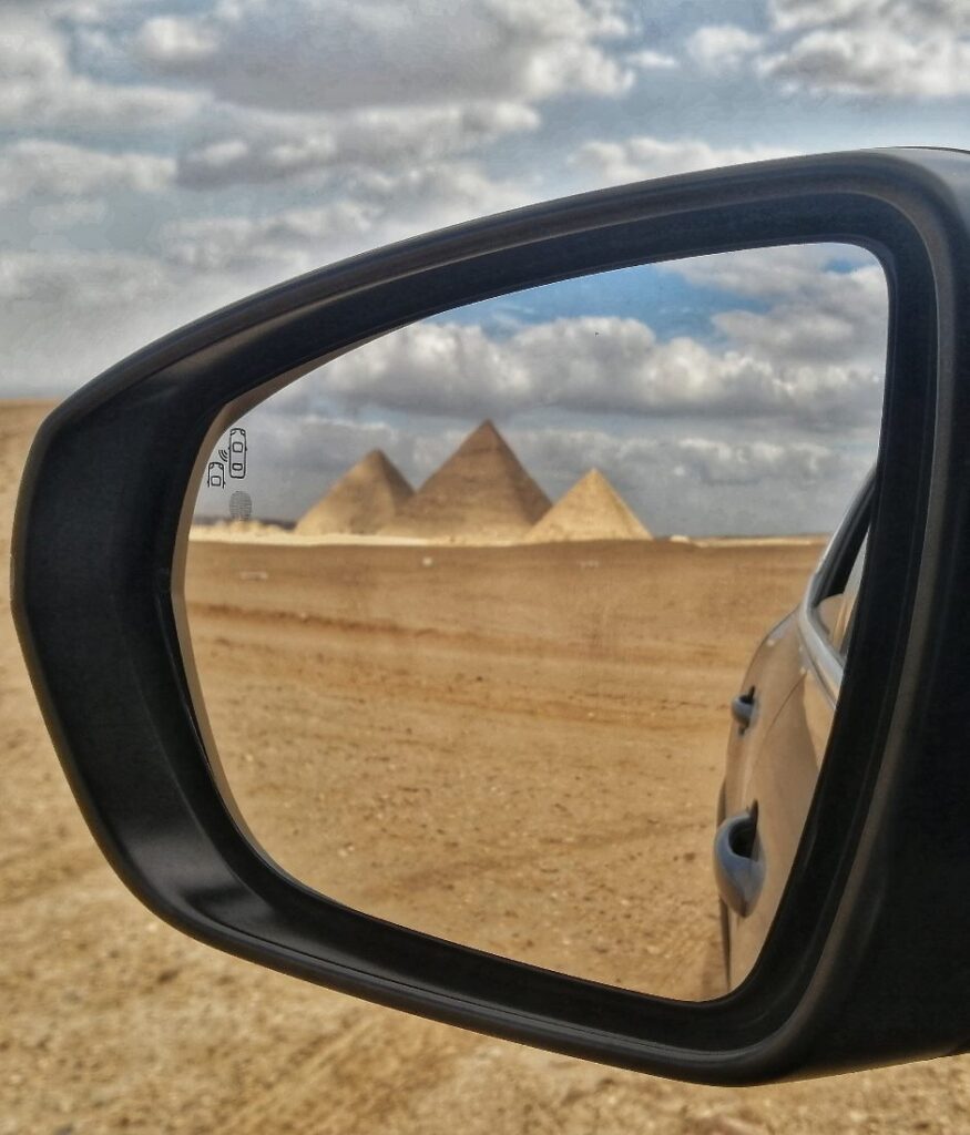 Reflection of Giza Pyramids on a cloudy day by Passainte Assem